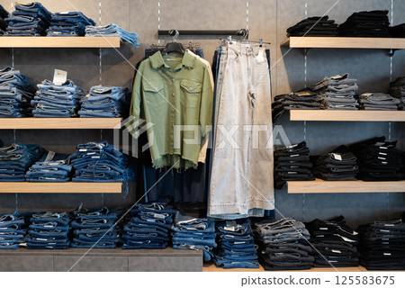 Stack of blue jeans in a shop. Stack of blue jeans in a shop. 125583675