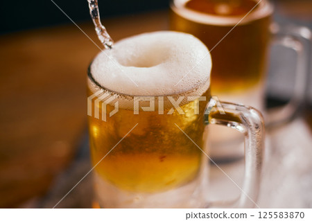 mug of beer on wooden table mug of beer on wooden table 125583870