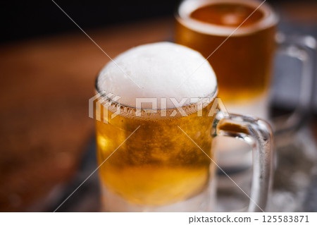mug of beer on wooden table mug of beer on wooden table 125583871