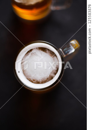 mug of beer on wooden table 125583876
