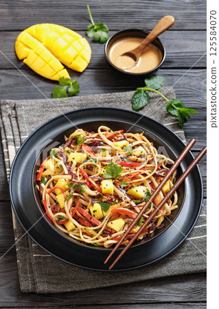 Thai Mango Noodle Veggie Salad in a bowl 125584070