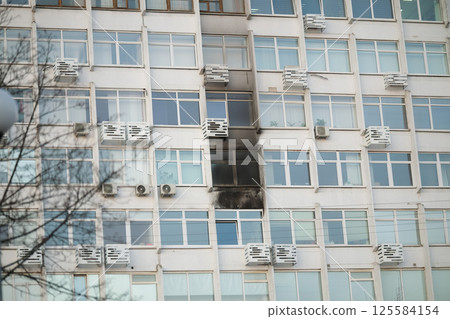 Consequences of a fire in a multi-storey building. Damaged multi-storey building, the aftermath of the explosion 125584154