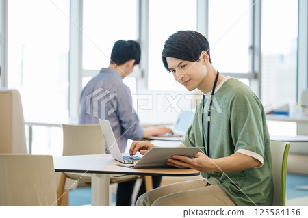 Young engineers working in a coworking space 125584156