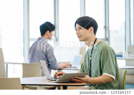 Young engineers working in a coworking space 125584157