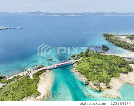 Aerial shot of the red Ikei Bridge on an isolated island in Uruma, Okinawa, taken using a drone Aerial shot of the red Ikei Bridge on an isolated island in Uruma, Okinawa, taken using a drone 125584174
