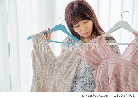 A woman choosing clothes A woman choosing clothes 125584401