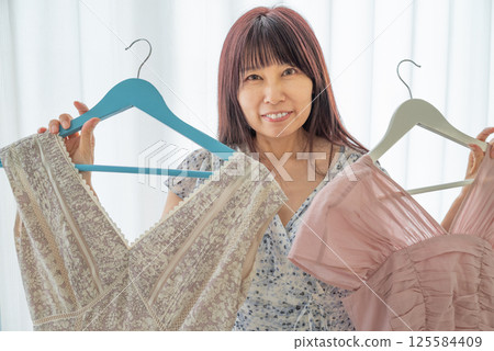 A woman choosing clothes A woman choosing clothes 125584409
