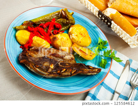 Tasty beef baked with potatoes and stewed peppers served Tasty beef baked with potatoes and stewed peppers served 125584612