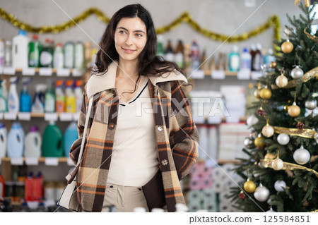 Spanish woman choosing products on Christmas Spanish woman choosing products on Christmas 125584851
