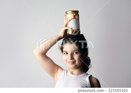 Little girl holding a pickled glass conserve on her head mock-up series Little girl holding a pickled glass conserve on her head mock-up series 125585165