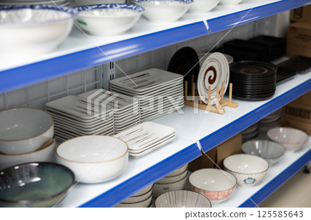 Shelves with various noodle bowls and plates in Asian store Shelves with various noodle bowls and plates in Asian store 125585643