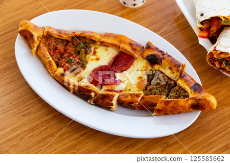 Turkish meat pide on plate. homemade food Turkish meat pide on plate. homemade food 125585662