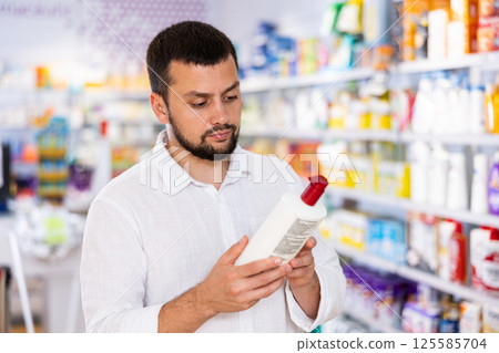 Man choosing skin care product in pharmacy 125585704