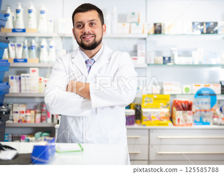Portrait of smiling man druggist standing at counter 125585788
