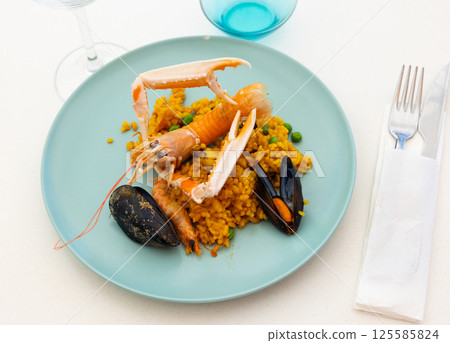 Seafood paella with lobster, mussels, calamari, shrimps 125585824