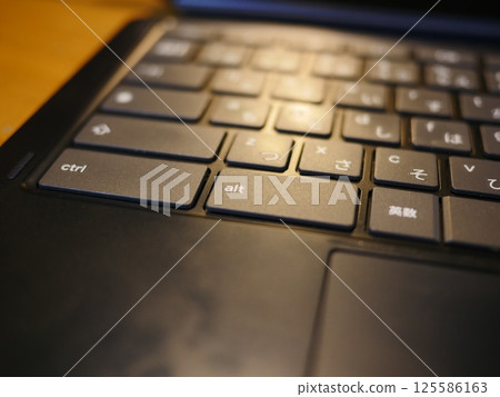 Smartphone on the table, computer keyboard and remote control, copy space, casual view at home 125586163