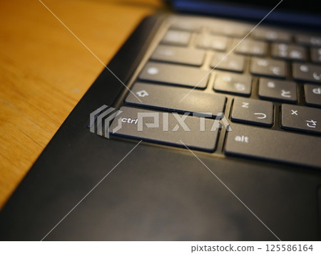 Smartphone on the table, computer keyboard and remote control, copy space, casual view at home 125586164