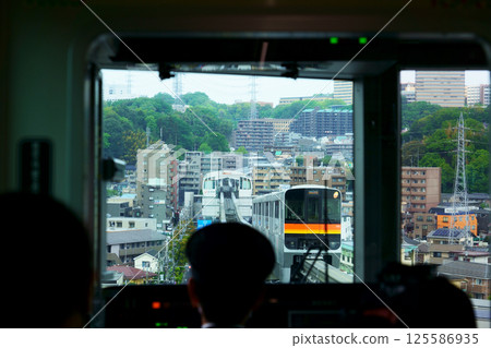 The Tama Monorail passing each other near Otsuka Teikyo University Station The Tama Monorail passing each other near Otsuka Teikyo University Station 125586935