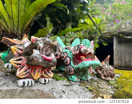 Shisa placed on a rock 125587018