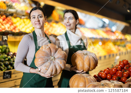 Female sellers holding pumpkin Female sellers holding pumpkin 125587184