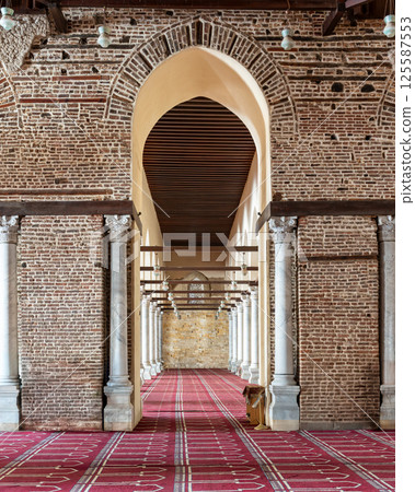 Mosque of al-Zahir Baybars in Cairo, Egypt, through an archway, featuring brick walls, and marble columns Mosque of al-Zahir Baybars in Cairo, Egypt, through an archway, featuring brick walls, and marble columns 125587553