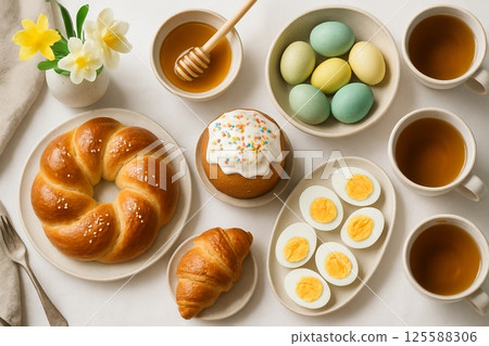 Easter Breakfast Spread with Fresh Pastries, Honey, Eggs, and Tea. Concept of Festive Morning Meal, Celebration, Fresh Ingredients, and Breakfast Tradition 125588306