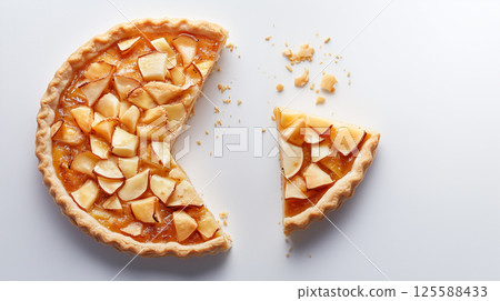 Top view of apple pie with one slice cut out on white background Top view of apple pie with one slice cut out on white background 125588433