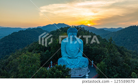 Aerial view of Majestic Buddha on the mountain at colorful sunrise Aerial view of Majestic Buddha on the mountain at colorful sunrise 125589070