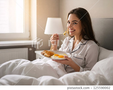 Smiling woman enjoying breakfast in bed. concept of morning rituals, cozy comfort, relaxation 125590002