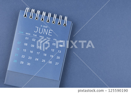 June 2026 calendar on blue background. Desk calendar for planning and organizing. June 2026 calendar on blue background. Desk calendar for planning and organizing. 125590190