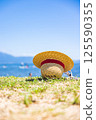 Straw hat on the beach 125590355