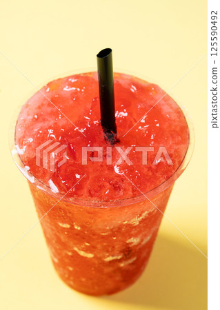 Red strawberry slushie isolated on yellow background. 125590492