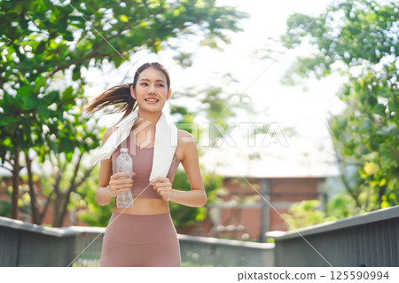 Southeast young asian woman running cardio exercise at outdoor with sunlight 125590994