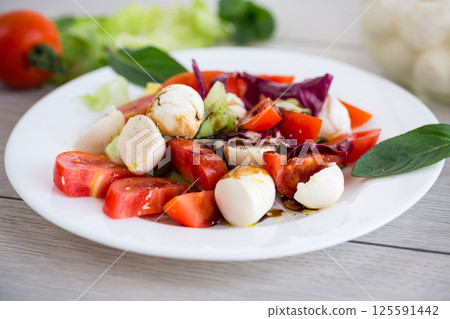 Classic Italian caprese salad for dinner 125591442