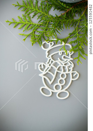 Christmas composition with a white ball and a snowman in the snow Christmas composition with a white ball and a snowman in the snow 125591482