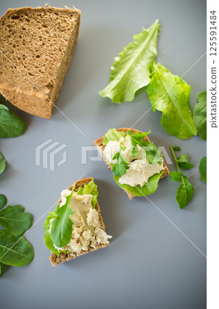 Isolated sandwich with rye bread and herring on the background 125591484