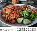 Traditional West African Benachin Rice with Fresh Vegetables on a White Plate 125592133