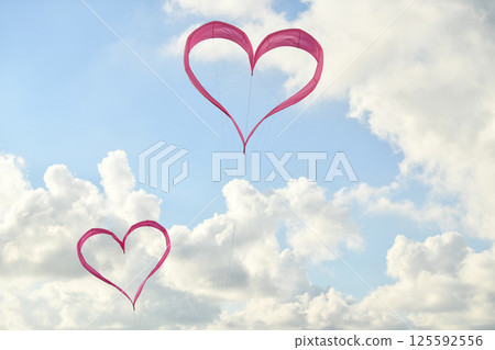 Pink heart kite is flying in the wind 125592556