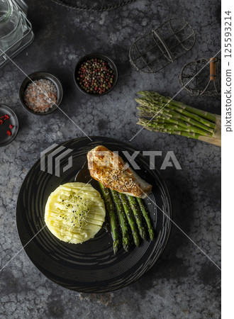 Sesame crusted chicken breast served with mashed potatoes and asparagus Sesame crusted chicken breast served with mashed potatoes and asparagus 125593214