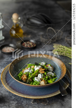 Delicious chicken salad with green peas, asparagus and yogurt sauce, garnished with black sesame seeds Delicious chicken salad with green peas, asparagus and yogurt sauce, garnished with black sesame seeds 125593215