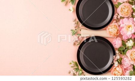 Close-up of glossy Japchae noodles with sauteed vegetables being lifted by chopsticks against a neutral background 125593282