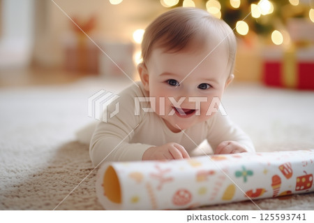Baby joyfully opens first gift in cozy living room with holiday lights and wrapping paper all around 125593741