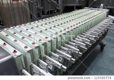 Filter press squeezing grape juice for winemaking in modern winery 125593774