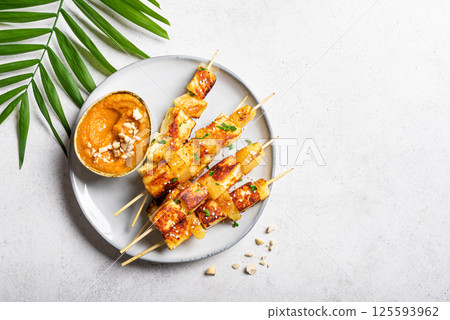 Grilled tofu satay skewers and peanut spicy sauce 125593962