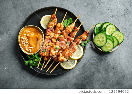 Grilled chicken satay with spicy peanut sauce Grilled chicken satay with spicy peanut sauce 125594022