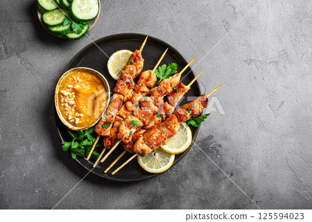 Grilled chicken satay with spicy peanut sauce Grilled chicken satay with spicy peanut sauce 125594023