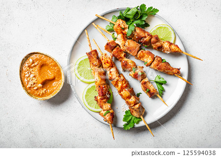 Malaysian chicken satay skewers with peanut sauce 125594038