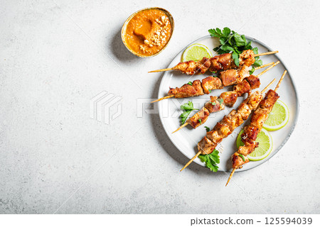 Malaysian chicken satay skewers with peanut sauce 125594039