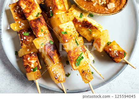 Grilled tofu satay skewers and peanut spicy sauce Grilled tofu satay skewers and peanut spicy sauce 125594045