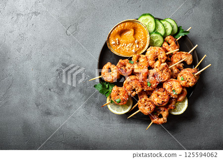 Grilled shimp prawn satay with spicy peanut sauce Grilled shimp prawn satay with spicy peanut sauce 125594062